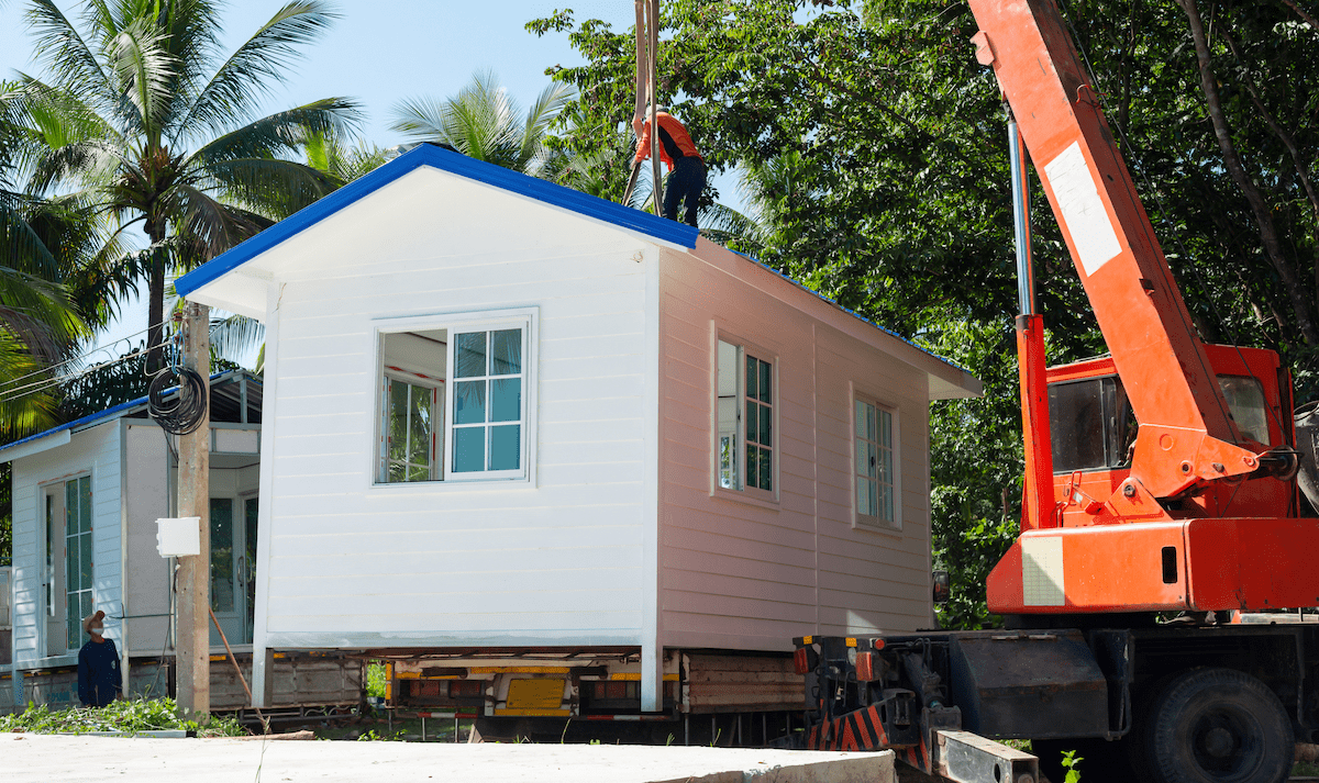 Manufactured home being craned into place on home site