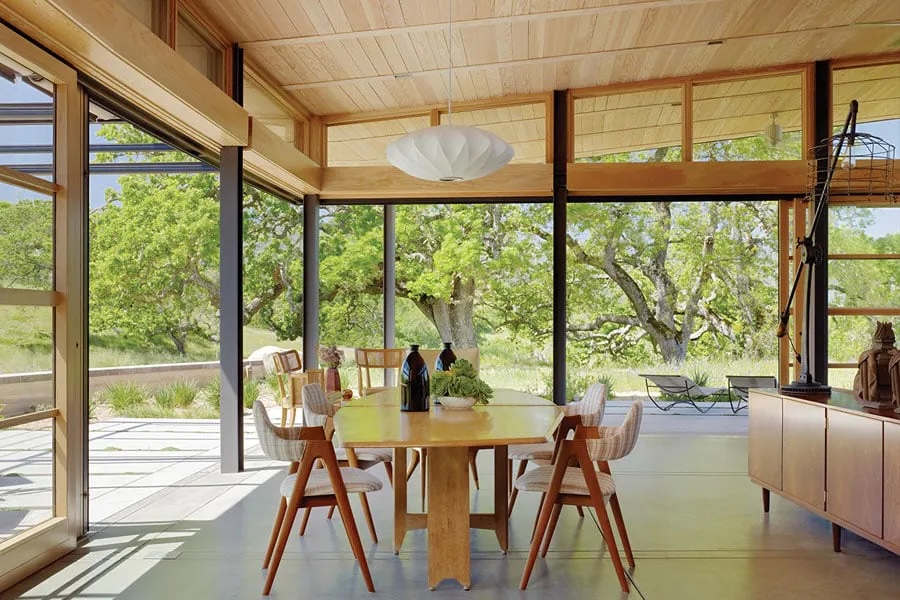 Open glass doors merge indoor and outdoor living