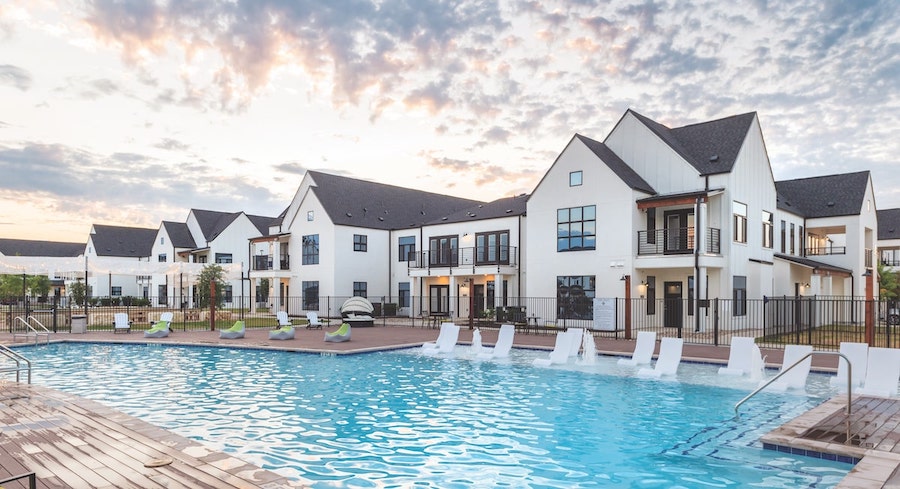 Hermosa Village outdoor pool surrounded by multifamily rental buildings in modern farmhouse style