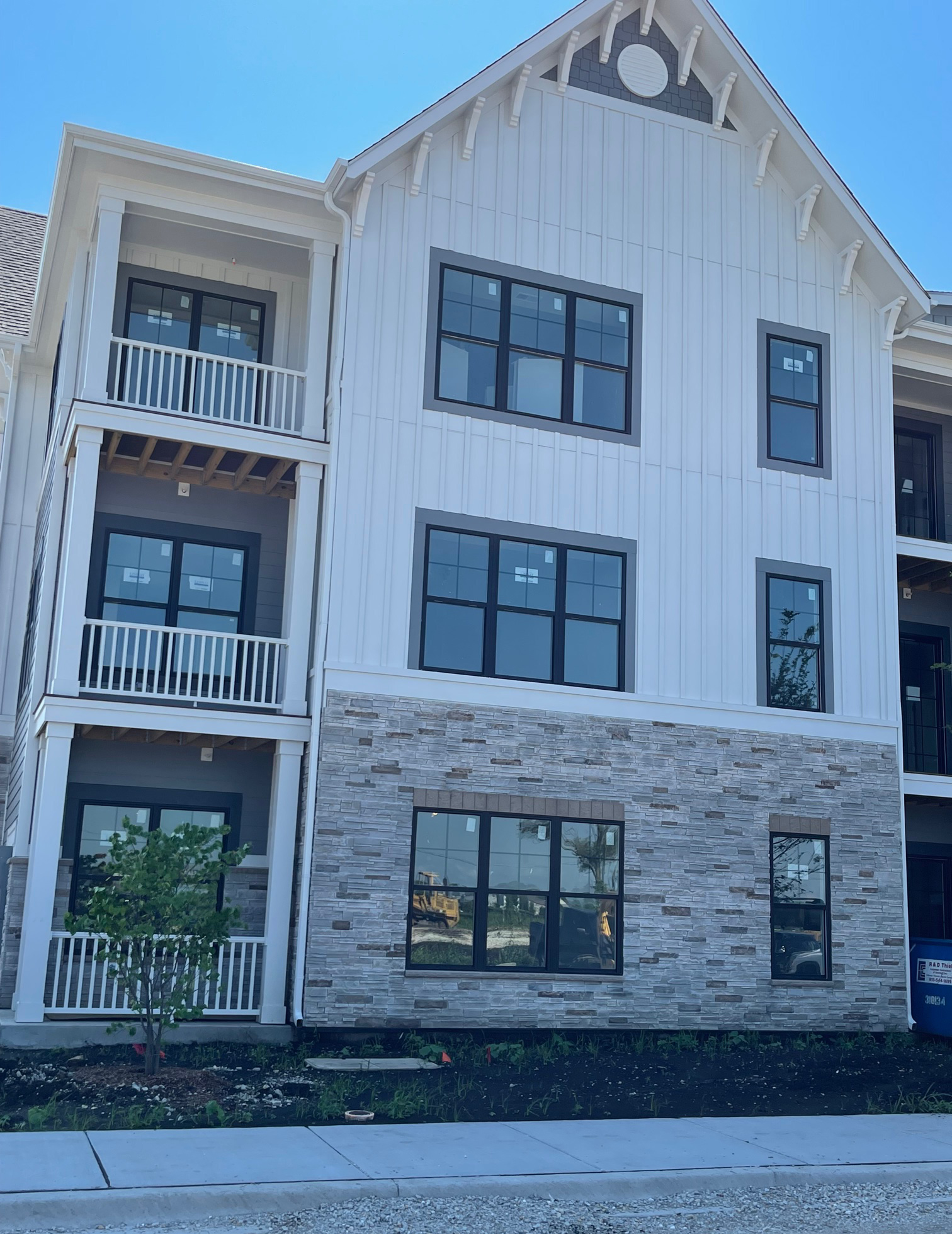 Board-and-batten siding made with TruExterior poly-ash trim combines with Versetta Stone siding to give this building the sought-after style