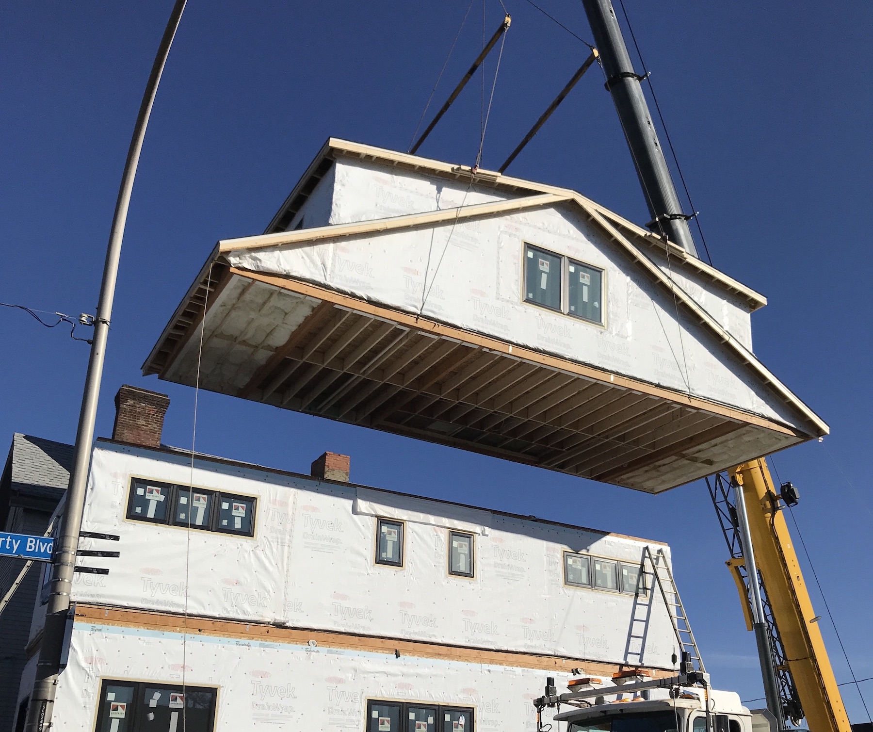 Module project shows residential attic being placed atop of existing modular pieces