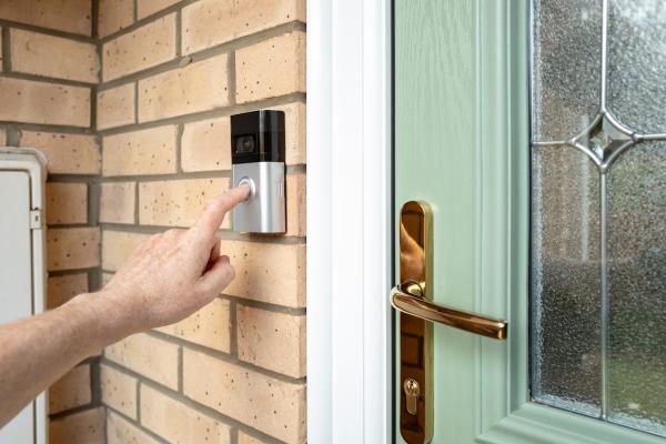 A person rings a smart door bell. 