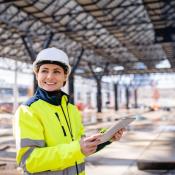 Female construction worker poses at jobsite