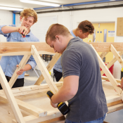 Students learning carpentry skills in a construction trades class