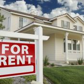 Single-family home with red "For Rent" sign posted in front lawn