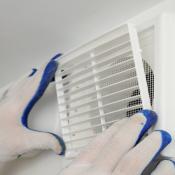 Worker installs ventilation grill