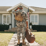 U.S. Army veteran stands outside home looking at front door