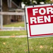 "For Rent" sign outside a rental home