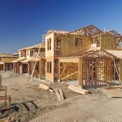 A row of single-family homes sits under construction