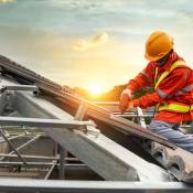 A construction worker works on a roof