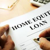 A homeowner signs a home equity loan