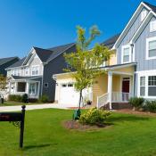 A row of new-construction homes in a residential neighborhood