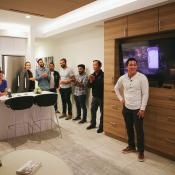 Group standing in modular apartment unveiling event Cloud S