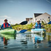 Older couple kayaking in adult living community