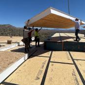 Craning a SIPs roof panel in place