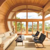 Wood windows and doors from Marvin installed in a home with a unique curved roof design