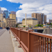 View of Minneapolis skyline with pedestrians on bridge