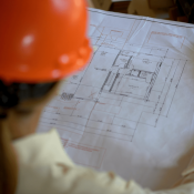 Woman construction worker reviews house plan