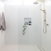 Large glass shower in white modern bathroom