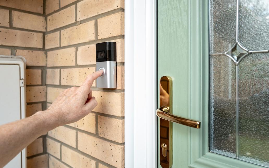 A person rings a smart door bell. 