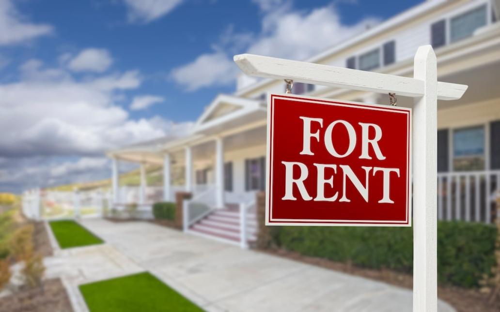 A single-family rental community with a "For Rent" sign in the front yard