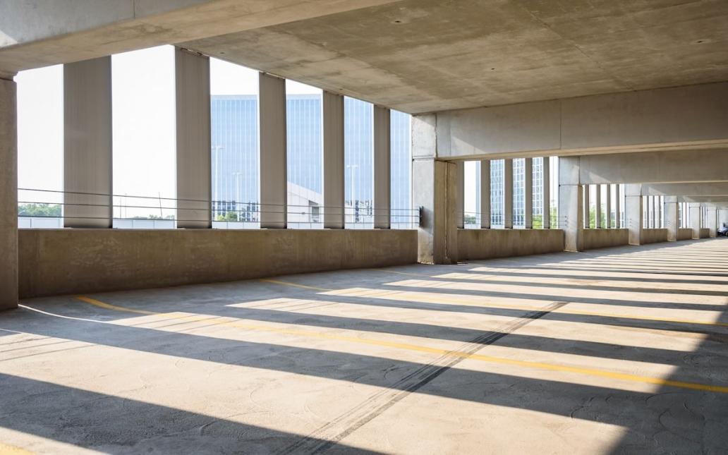 An empty parking garage overlooking a city