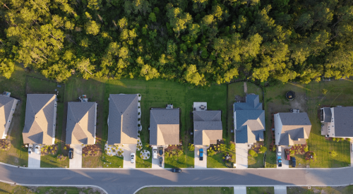 Aerial view of row of homes at woods edge