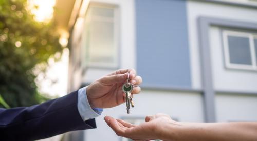 Real estate agent handing keys of new house to a homebuyer