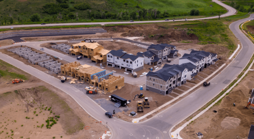 Aerial view of new housing development with homes at different stages of construction