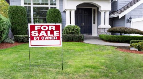 A sign reading "For Sale By Owner" sits in front yard of single-family home