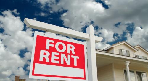 Red "For Rent" sign sits outside of single-family home