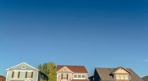 row of suburban homes against blue sky