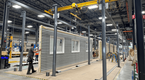 Assembling building panels in an off-site construction plant