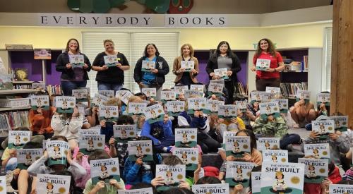 Students at Hazelwood Elementary in Edmonds, Wash. hold up their newly received "House That She Built" books