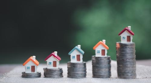 Model homes sit on stacks of coins that increase in height from left to right