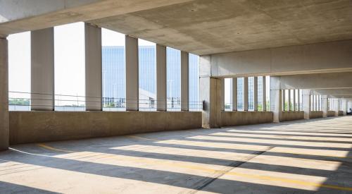 An empty parking garage overlooking a city