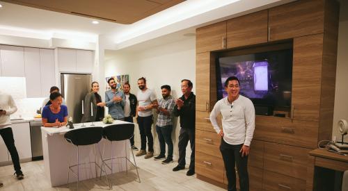 Group standing in modular apartment unveiling event Cloud S