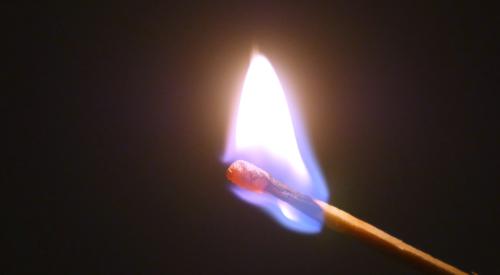 Match stick on fire with blue flame