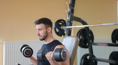 Man lifting weights in home gym