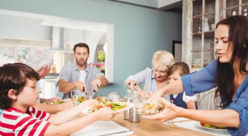 Multigenerational household eating a meal together