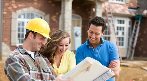 Homeowners smiling at designs with home builder