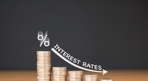 Coins decrease in size with an arrow. Above that are the words 'Interest rates.'