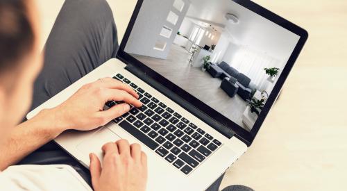 Person viewing home on laptop