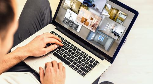 Man looking at homes on laptop
