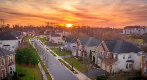Suburban street with houses during sunset