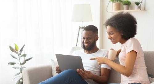 Smiling couple looking at tablet