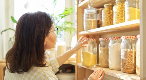 Woman looking in kitchen pantry