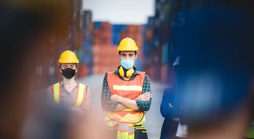 Two construction workers with face masks on