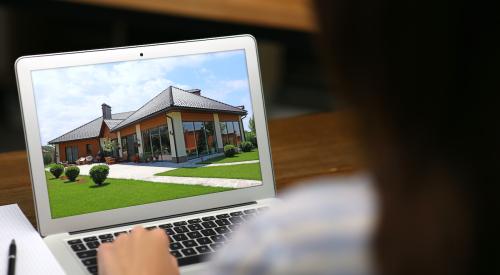 Person viewing home on laptop