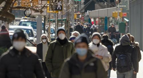 People walking in city wearing masks